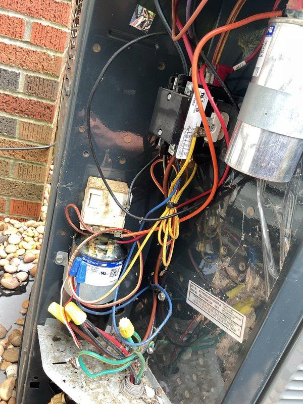 Completed MVP cooling maintenance visit on residential HVAC system. Inspected electrical components within outdoor condensing unit, identifying two blown 2-amp fuses (SPD and TRD5RE rated) that required replacement. Removed failed fuses from their black plastic holders and installed new fuses to restore proper system operation. Examined capacitor, contactor assembly, and associated wiring connections, noting normal wear consistent with system age. All electrical connections were secure with proper wire management in place. System tested and confirmed operational following fuse replacement.