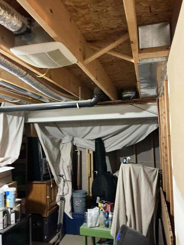 Conducted site assessment for electric vehicle charging station installation at a 23-year-old residential property. Evaluated existing electrical infrastructure including outdoor electrical service access panel located in lawn area and basement electrical panel accessibility. Documented current electrical system configuration, noting exposed basement ceiling with existing electrical distribution, HVAC ductwork, and available routing pathways for new dedicated circuit installation. Assessed optimal placement options for EV charger considering distance from main electrical panel to proposed charging location, required conduit runs, and compliance with current electrical codes for EVSE installations.