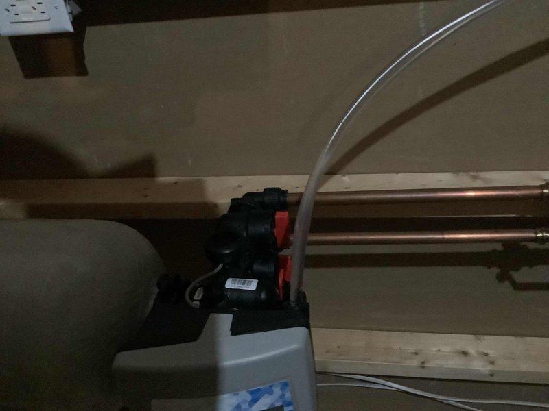 Responded to service call for broken drain line from water softener system that had been previously installed approximately two years prior. Upon inspection, identified failed drainage connection in utility area of 30-year-old residential property. Repaired compromised drain line to restore proper water softener discharge function and prevent water damage to basement area.