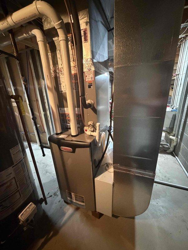 Completed full HVAC system installation in basement, including 80% AFUE gas furnace with matching air handler unit and associated ductwork. Installed new insulated supply plenum and metallic flex duct connections to existing distribution system. Mounted and connected humidifier accessory to furnace unit for enhanced indoor air quality. All equipment properly positioned on concrete floor with appropriate clearances from concrete block walls and structural framing. Verified all electrical connections, gas line connections, and condensate drainage routing. System tested and operational.