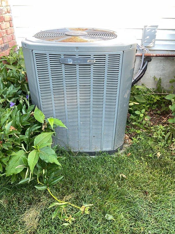 Completed preventive maintenance service on two residential split-system air conditioning units (7-year-old and 10-year-old models). Performed comprehensive inspection of both outdoor condensing units, including visual examination of electrical components, capacitors, and wiring connections. Observed dual-capacitor rated at 50+5μF in serviceable condition with proper terminal connections. Noted typical age-related accumulation of environmental debris including dust, dirt, and cobwebs on interior components and wiring. Exterior unit housing showed surface oxidation and discoloration on fan grill consistent with outdoor exposure. All electrical connections secure with no signs of overheating or arcing. Units operational at time of inspection with proper airflow through louvered panels.
