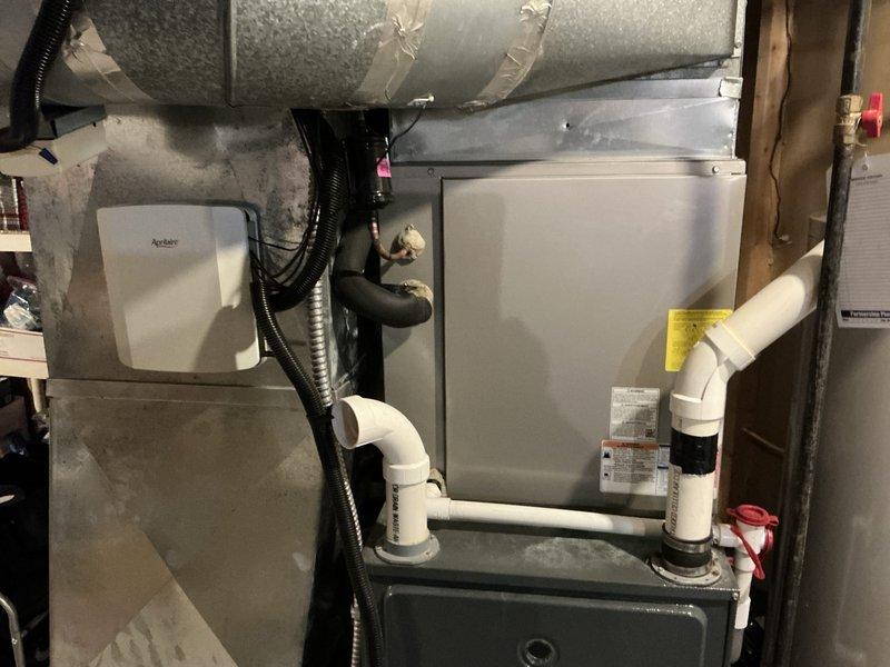 Conducted comprehensive estimate for complete HVAC system replacement in residential basement installation. Evaluated existing furnace/air handler unit, Aprilaire humidification system, condensate drainage configuration with PVC piping, and multi-zone ductwork serving second floor, documenting current equipment condition and installation specifications to provide replacement options for customer consideration.