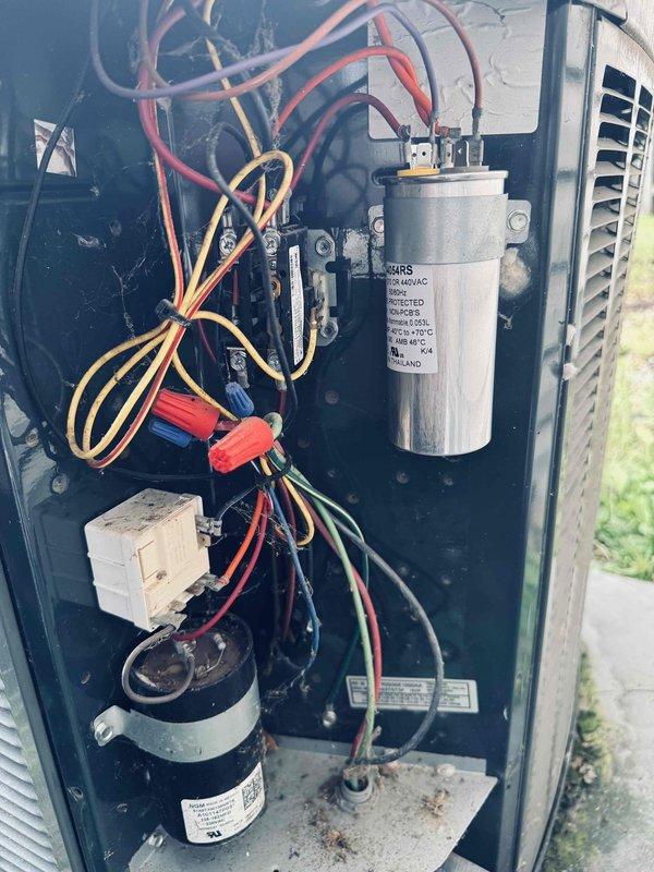 # HVAC Service Report

Responded to no-cooling complaint on 13-year-old residential air conditioning system affecting entire home. Upon arrival, opened outdoor condensing unit access panel and performed visual inspection of electrical and mechanical components. Found aged capacitor with visible wear, contaminated terminal block connections with heavy dust and cobweb accumulation, and degraded wire connections showing signs of oxidation on brass terminals. Inspected compressor contactor, relay assembly, and internal wiring configuration. Documented existing conditions of all major electrical components including capacitor, compressor connections, and control wiring. Unit showed typical age-related deterioration with debris buildup throughout interior compartment. Provided customer with findings and recommendations for necessary repairs to restore cooling operation.
