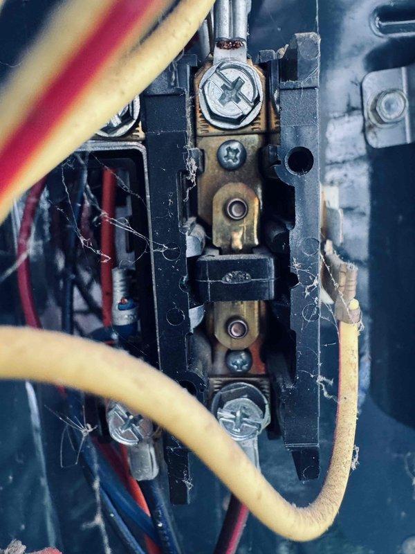 # HVAC Service Report

Responded to no-cooling complaint on 13-year-old residential air conditioning system affecting entire home. Upon arrival, opened outdoor condensing unit access panel and performed visual inspection of electrical and mechanical components. Found aged capacitor with visible wear, contaminated terminal block connections with heavy dust and cobweb accumulation, and degraded wire connections showing signs of oxidation on brass terminals. Inspected compressor contactor, relay assembly, and internal wiring configuration. Documented existing conditions of all major electrical components including capacitor, compressor connections, and control wiring. Unit showed typical age-related deterioration with debris buildup throughout interior compartment. Provided customer with findings and recommendations for necessary repairs to restore cooling operation.