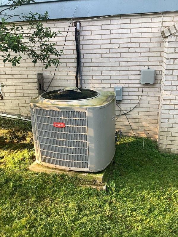Completed installation of new Bryant air conditioning system including outdoor condensing unit and indoor evaporator coil. Outdoor unit was positioned on concrete pad against exterior wall with proper clearances maintained, refrigerant lines insulated and secured along wall penetration, and electrical disconnect installed per code requirements. Indoor evaporator coil was mounted above existing furnace with proper drainage provisions, supply and return ductwork connections completed using rigid sheet metal construction, and all refrigerant line sets brazed and pressure tested. System was evacuated, charged to manufacturer specifications, and tested for proper operation including temperature differential verification and electrical component functionality.