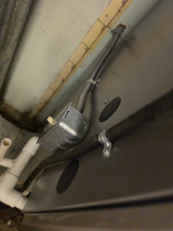 Completed installation of a downflow 90% efficiency furnace in residential garage location, reusing existing flue system as specified. Installed unit with proper venting configuration, connected gas piping with appropriate shut-off valve, and established condensate drainage using PVC piping with drip pan protection. All mechanical connections secured and system tested for proper operation.