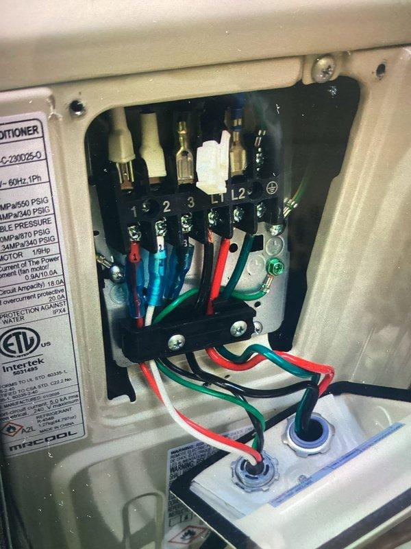 Responded to service call for newly installed central air conditioning system that failed to start. Upon arrival, inspected outdoor condenser unit and electrical connections. Found improper wiring at terminal block inside condensing unit's electrical panel. Corrected wire connections per manufacturer specifications, ensuring proper voltage supply to compressor and fan motor. Verified all terminal connections were secure and properly seated. Tested unit operation and confirmed system startup, with compressor and condenser fan running normally. System now operating as designed.