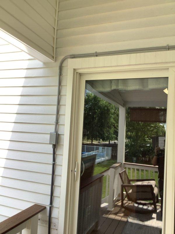 Installed a new ceiling fan with integrated lighting in the covered porch area, utilizing surface-mounted PVC conduit routed along the exterior wall to supply power to the fixture. Added an interior wall switch near the door for fan control. Relocated an existing electrical box on the home's exterior that had been obstructed by newly installed deck railing, repositioning it toward the stairs to restore access. Installed a video doorbell at the front entrance with proper wiring connections.