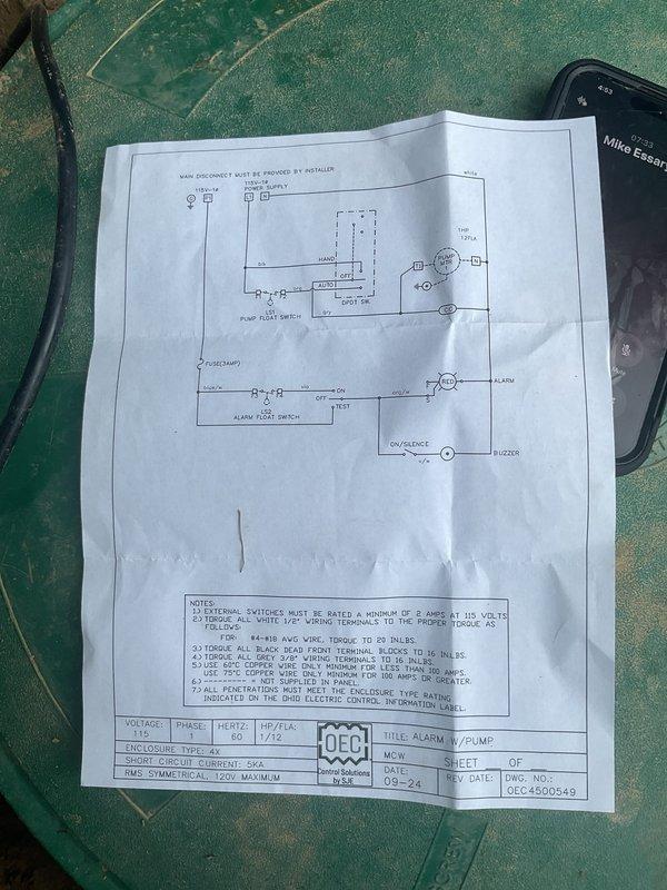 Responded to callback for ongoing alarm system issues with GFI breaker tripping. Inspected outdoor electrical control panel containing pump and alarm float switch controls with digital counter and manual override switches. Reviewed wiring diagram and verified connections at terminal strip, examining multi-conductor wiring routing and grounding. Customer reported alarm malfunction recurring immediately after previous service visit and requested proper outlet box installation without silicone sealing method used previously.