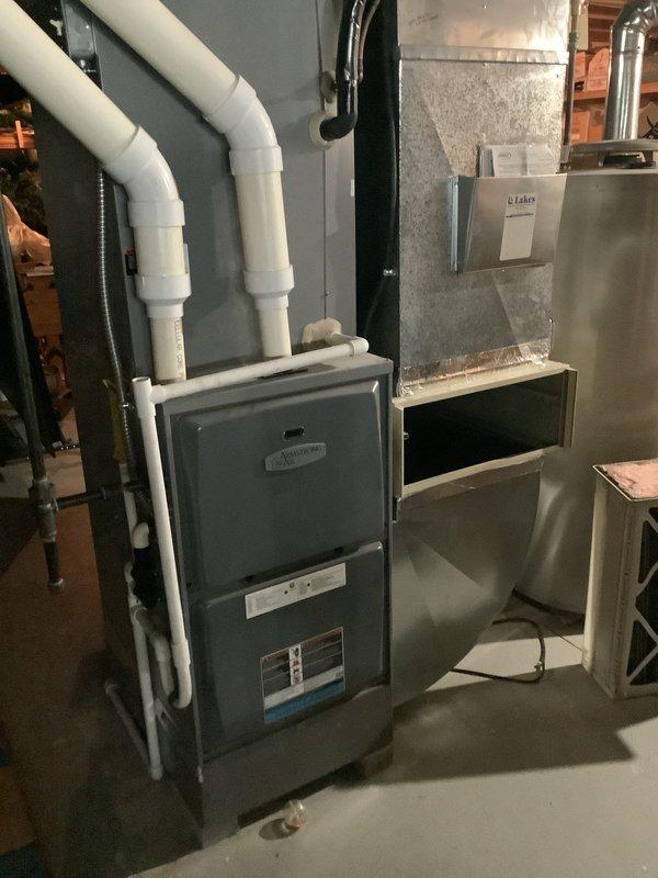 Responded to no cooling complaint on approximately 10-year-old residential air conditioning system. Upon arrival, found outdoor condenser unit heavily soiled with accumulated dirt and debris on exterior panels and coils, with vegetation growth around base potentially restricting airflow. Inspected indoor furnace and air handler equipment in basement, noting standard forced-air configuration with PVC condensate drainage system. Diagnosed cooling issue, performed necessary repairs to restore system operation, and recommended routine maintenance including coil cleaning and vegetation clearance to ensure optimal performance and efficiency.
