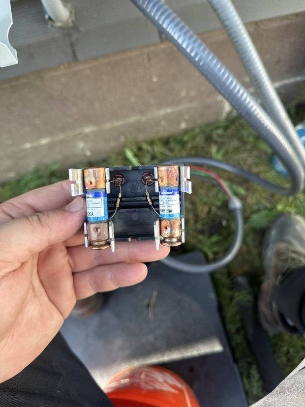 Completed installation of standard central air conditioning system and ducted mini split unit over two-day period. Replaced corroded cartridge-style fuses showing significant rust and moisture damage on exterior electrical connections. Installed new outdoor condensing unit on equipment pad with proper refrigerant line connections, drainage assembly, and electrical conduit routing. All copper piping secured with appropriate insulation and weatherproofing, brass fittings properly mounted to equipment cabinet, and system tested for proper operation.