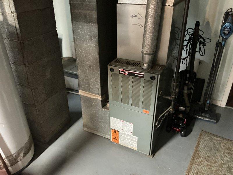 Completed comprehensive estimate for full residential HVAC system replacement at property with 25-year-old existing equipment. Inspected current Ruud furnace installation in basement mechanical room and exterior condensing units positioned on gravel pad against foundation. System currently operational with no reported issues; replacement quote requested proactively due to age of equipment. Documented existing equipment configuration, ductwork connections, electrical service, and outdoor unit placement. Verified available promotional offers for combined furnace and air conditioning replacement package. Provided detailed replacement options and pricing for complete system upgrade.