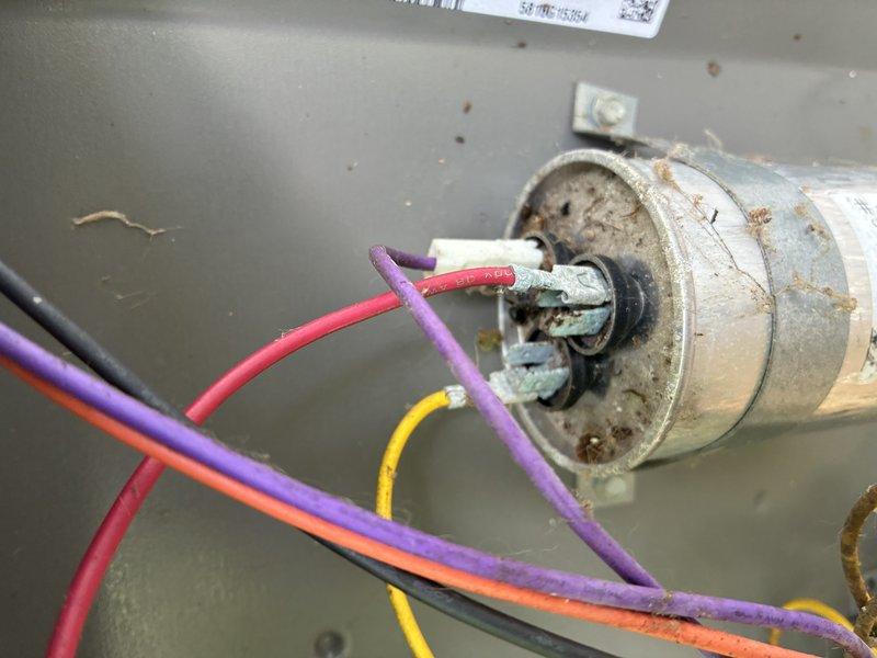 Completed routine MVP cooling maintenance visit on HVAC system. Inspected and photographed dual run capacitor showing age-related wear and surface oxidation with all electrical connections intact, and verified service disconnect box properly secured and operational. All system components functioning within normal parameters at time of service.