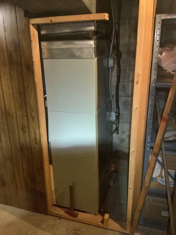 # HVAC Install - Complete System

Completed installation of 80% AFUE gas furnace and air handler system in residential basement mechanical room. Removed existing equipment and installed new furnace unit with proper venting and gas line connections. Positioned air handler within existing wooden frame structure and integrated black flexible ductwork for proper airflow distribution. Connected all necessary refrigerant lines, electrical wiring, and condensate drainage per manufacturer specifications. Verified proper clearances around water heater and ensured all safety codes were met. System tested and confirmed operational with proper temperature rise and airflow measurements. All equipment secured, labeled, and ready for service.
