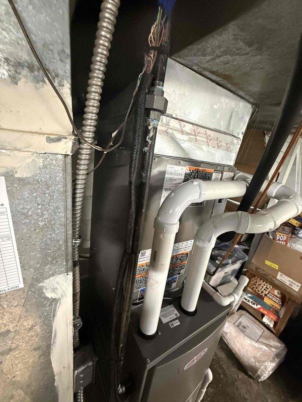 # HVAC Install - Complete System

Successfully completed installation of a 90% efficiency air conditioning system. The installation included mounting and connecting a new air handler unit in the utility space with proper PVC condensate drain lines and venting configured according to manufacturer specifications. All electrical connections were secured with appropriate conduit and wire management. System startup procedures were performed, and temperature readings were verified at 60.5°F to confirm proper operation. Unit was tested for correct airflow, refrigerant charge, and drainage functionality to ensure optimal performance and efficiency.