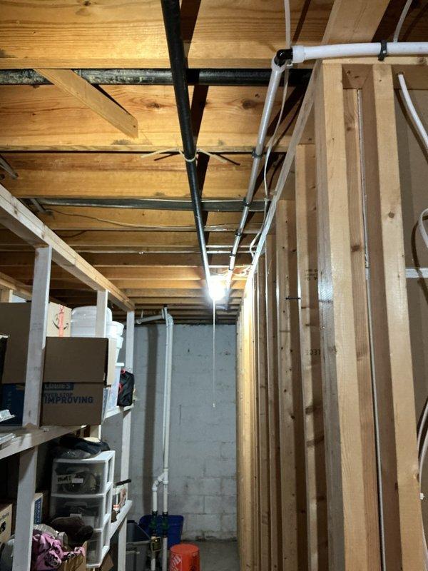 Replaced ruptured 5/8" water softener discharge line with upgraded 3/4" PEX piping running approximately 50 feet to sump crock. Installed 3/4" PEX female adapter threaded to softener head and secured new discharge line along basement ceiling joists to drainage point. System tested and verified proper flow with no leaks detected.