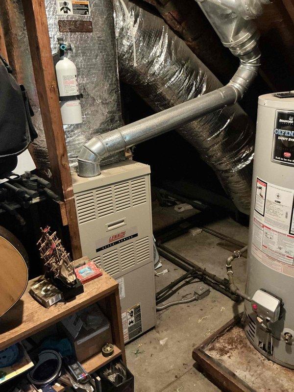 Conducted on-site evaluation for central air conditioning system installation in a late 1950s residential property with no existing cooling system. Previous AC unit from approximately 1970s had been removed, requiring assessment of existing ductwork infrastructure, electrical capacity, and optimal equipment placement. Inspected basement mechanical room containing Lennox furnace and existing ductwork system to determine compatibility with new AC installation. Photographed current HVAC setup including furnace unit, metallic supply ductwork with reflective insulation, and available space for new equipment connections. Evaluated electrical service capacity and confirmed furnace compatibility for AC coil integration. Provided comprehensive replacement estimate for complete central air conditioning system installation including outdoor condensing unit, indoor evaporator coil, refrigerant lines, condensate drainage, thermostat upgrade, and necessary electrical connections to restore cooling c