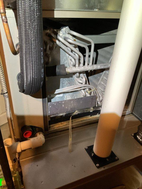 # HVAC Service Report - Water Leak Resolution

Responded to service call for water leaking from furnace system. Upon arrival, conducted thorough inspection of HVAC equipment and surrounding area. Discovered evaporator coils heavily frosted with significant ice buildup on both upper and lower coil sections, indicating restricted airflow or refrigerant issue causing coil to freeze. 

Identified that frozen coils were melting and causing water to overflow from condensate drain system, resulting in substantial water damage to carpeted floor in utility area. Water staining pattern indicated leak had been occurring over extended period before service call was initiated.

Checked air filter and found it may have contributed to restricted airflow across evaporator coils. Inspected condensate drain line and pan for proper drainage and potential blockages. Allowed system to defrost completely before further diagnosis.

Addressed immediate water leak issue and documented extent of water damage to