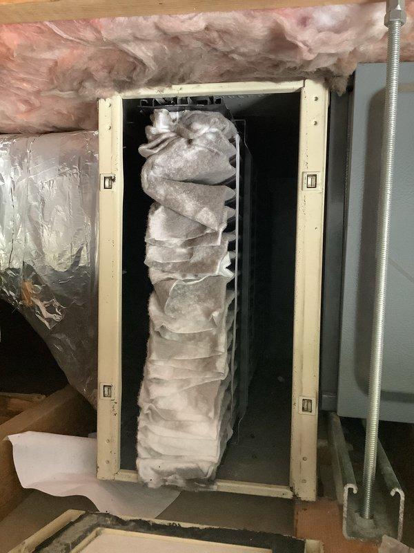Responded to service call for 19-year-old air conditioning system with clogged condensate drain line causing water accumulation in garage. Upon arrival, accessed air handler unit in attic space and inspected condensate drainage system. Located blockage in primary drain line preventing proper water discharge. Cleared obstruction from condensate line using appropriate tools and techniques to restore proper drainage flow. Verified condensate pump and trap assembly were functioning correctly. Tested system operation to confirm water was draining properly through cleared line with no further backup or overflow. System returned to normal operation with condensate draining as designed.