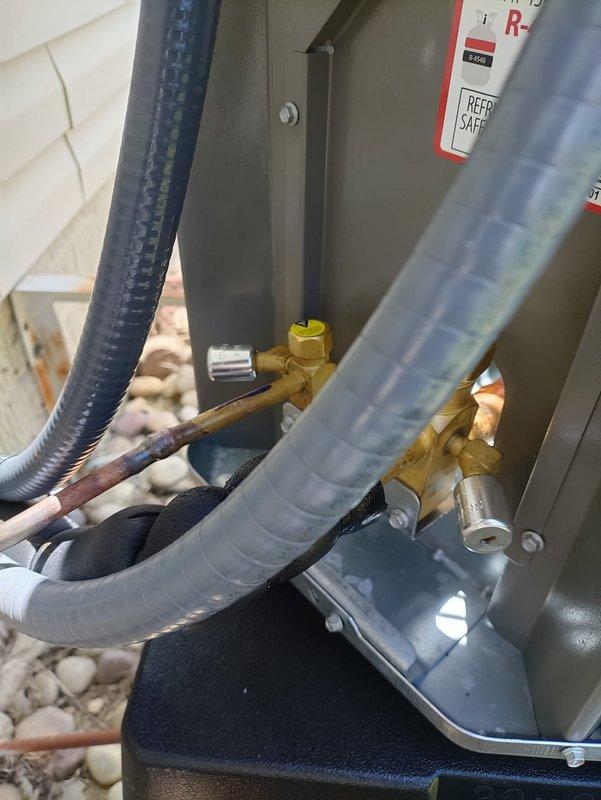 Completed full HVAC system installation including air handler unit with proper refrigerant line connections, insulated piping, and electrical components. Installed and verified dual-element time-delay fuses (FLNR 30, 250VAC) in disconnect housing, secured all refrigerant lines with appropriate insulation and mounting brackets, and ensured all connections met manufacturer specifications for safe operation.