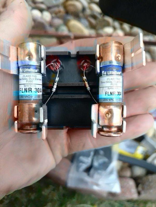 Completed full HVAC system installation including air handler unit with proper refrigerant line connections, insulated piping, and electrical components. Installed and verified dual-element time-delay fuses (FLNR 30, 250VAC) in disconnect housing, secured all refrigerant lines with appropriate insulation and mounting brackets, and ensured all connections met manufacturer specifications for safe operation.