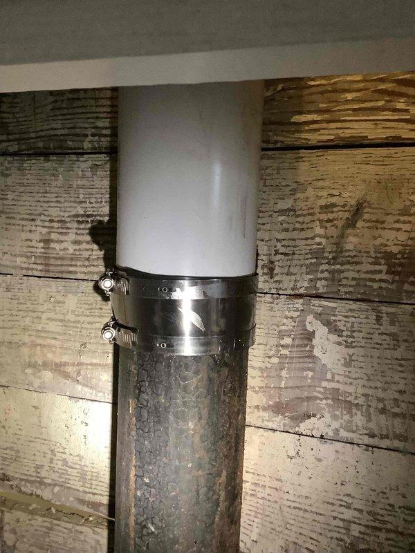 Replaced a cracked section of 4-inch cast iron drain pipe located within the wall cavity between the kitchen and basement stairwell. Cut access openings through drywall and beadboard paneling to expose the damaged cast iron pipe, removed the compromised section, and installed new PVC pipe with proper no-hub couplings and stainless steel clamps to ensure a watertight seal. Secured the new pipe assembly with metal brackets and restored structural integrity to the drainage system.