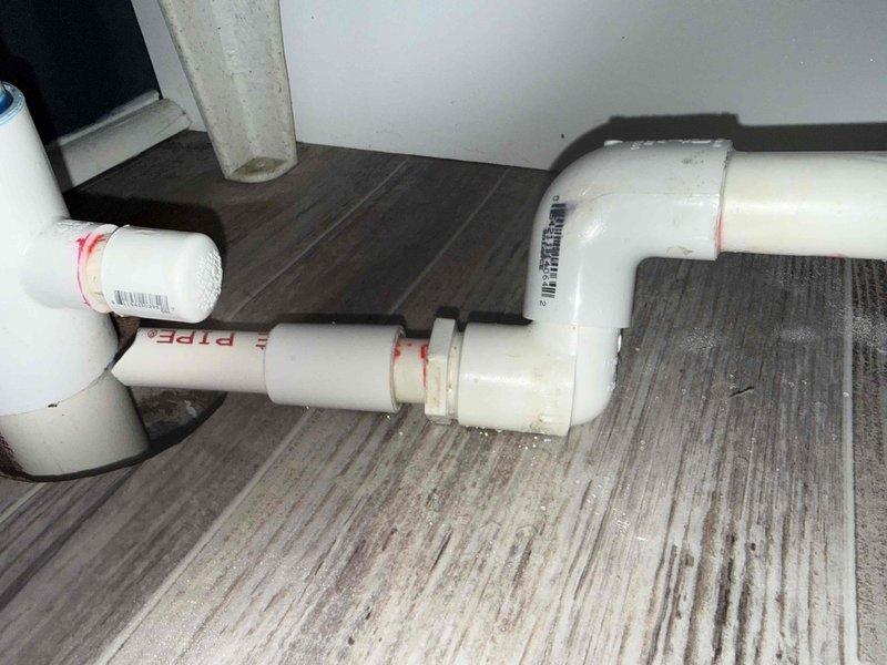 Responded to service call for condenser running continuously and evaporator coil leaking water onto utility room floor. Upon inspection, found Lennox furnace system with active condensate drainage issues causing water accumulation on floor. Documented existing PVC condensate drain line configuration and furnace installation with photographic evidence. Contacted property owner to report findings and discuss necessary repairs to address coil leak and condenser operation concerns.