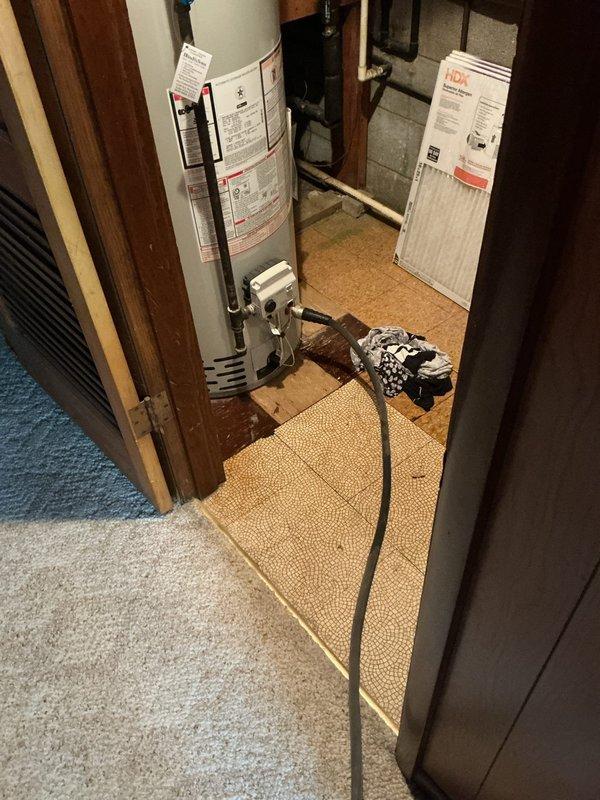 Performed routine maintenance flush on a 4-year-old tanked water heater located in basement utility closet. Drained sediment buildup from tank using hose routed through laundry area to floor drain, restored unit to optimal operating condition, and verified proper function upon completion.