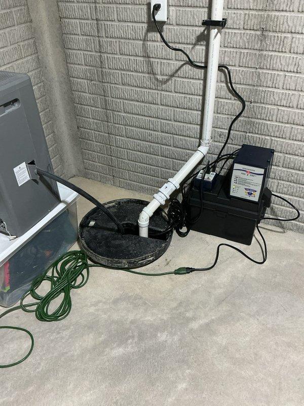 Replaced existing sump pump system with a Level 2 all-in-one primary and battery backup sump pump assembly to provide continued operation during power outages. Removed old pump from basin, installed new integrated system with battery backup unit, and configured all electrical connections and discharge piping. Tested primary pump operation and battery backup functionality to ensure proper automatic switching during power loss scenarios.