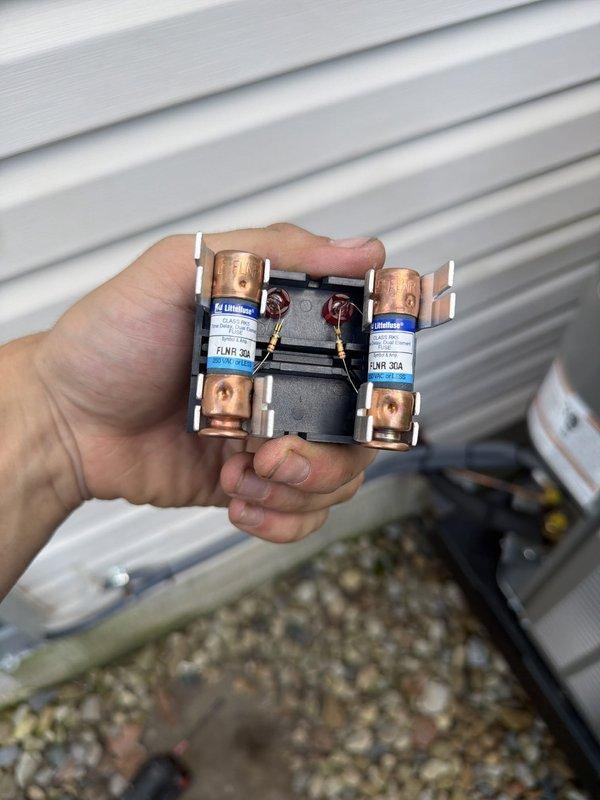 Completed first-time air conditioning system installation including outdoor condensing unit and evaporator coil. Installed and connected refrigerant lines with proper insulation, mounted service valves with Schrader ports for future maintenance access, and wired electrical components including 30-amp fuses and contactor. System was properly positioned on gravel pad, all copper lines were secured and insulated to prevent heat transfer, and unit was tested to ensure proper operation.