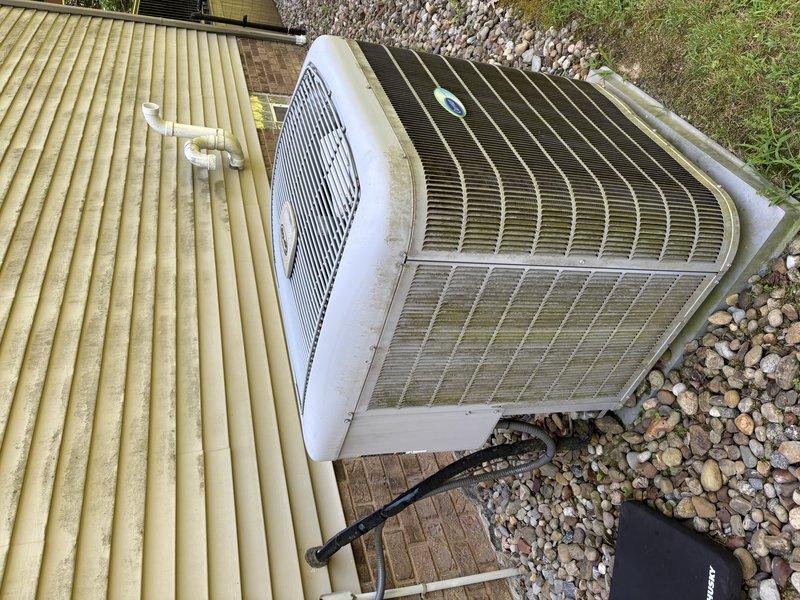 # HVAC Service Report

## Summary
Responded to service call for 12-year-old Carrier air conditioning unit displaying pressure error message and complete system failure. Performed diagnostic evaluation, accessed electrical compartment which revealed significant debris accumulation and weathering consistent with unit age, and documented outdoor condenser unit condition showing environmental exposure and maintenance needs.

## Work Performed

Arrived on-site to diagnose non-operational air conditioning system affecting entire residence. Unit presented with pressure-related error code on display. Conducted visual inspection of outdoor condenser unit positioned on composite deck platform with gravel surround.

Removed electrical compartment access panel to examine internal components and wiring. Found extensive accumulation of dirt, debris, and cobwebs throughout electrical compartment, indicating prolonged exposure to outdoor elements without routine maintenance. Inspected circuit board an