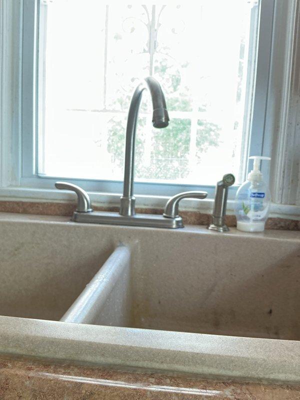 Responded to service call for leaking kitchen sink and bathroom sink. Upon inspection, identified deteriorated supply line connections and corroded shut-off valves beneath fixtures causing active water leaks. The aging metal plumbing components showed significant oxidation and mineral buildup compromising seal integrity at compression fittings.

Performed necessary repairs by replacing faulty compression fittings and tightening loose connections at supply lines. Addressed corroded shut-off valve connections to restore proper function and eliminate water seepage. Verified all drain line connections at white PVC assembly were secure with no signs of leakage. Tested both kitchen and bathroom sink fixtures under full water pressure to confirm successful repair and proper drainage. All leaks resolved and systems restored to normal operation.