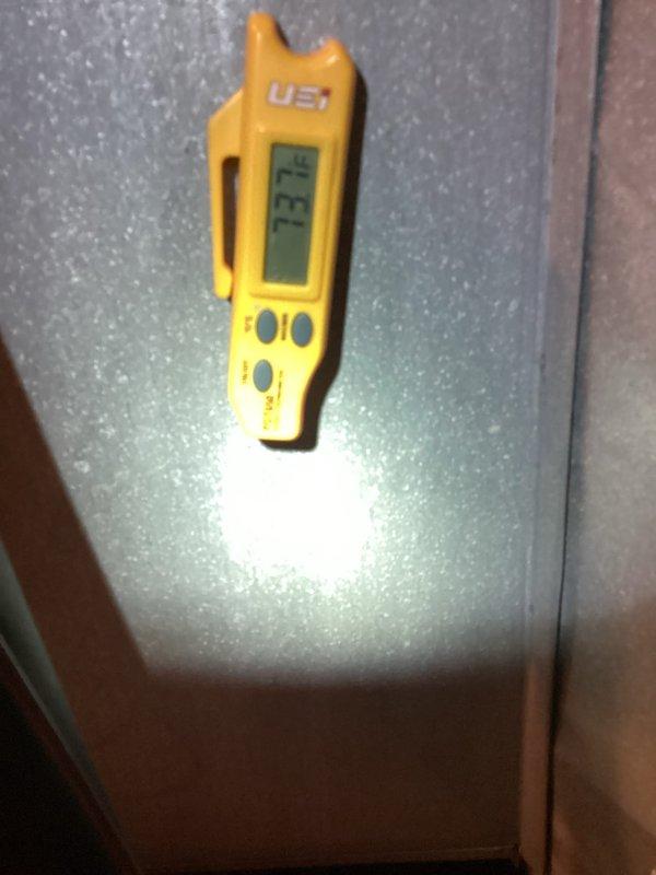 Responded to no cooling complaint on 7-year-old air conditioning system. Performed diagnostic temperature measurements at outdoor unit using infrared and digital thermometers to assess equipment operation and identify cause of cooling failure. Documented equipment conditions and temperature readings for service records.