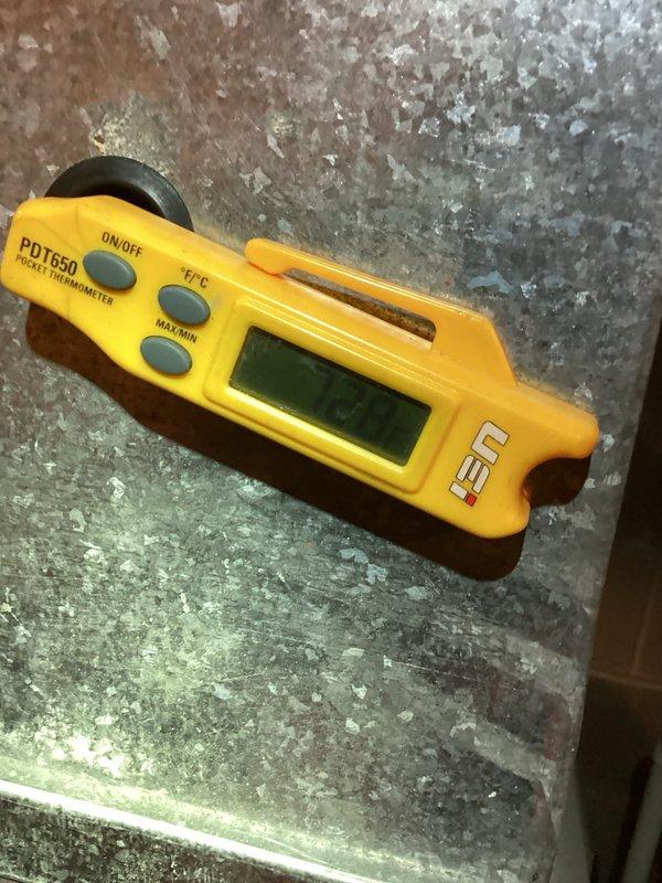 Responded to no cooling complaint on 7-year-old air conditioning system. Performed diagnostic temperature measurements at outdoor unit using infrared and digital thermometers to assess equipment operation and identify cause of cooling failure. Documented equipment conditions and temperature readings for service records.