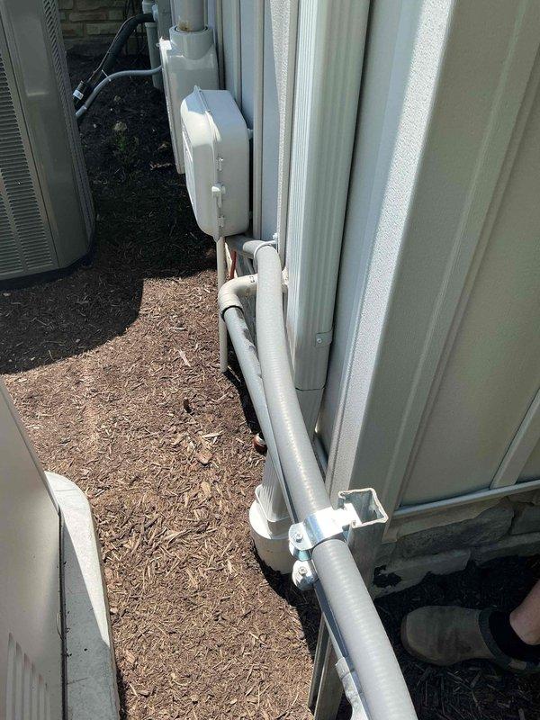 Responded to service call regarding reported gas odor near recently installed 22kW natural gas standby generator. Upon arrival, customer reported detecting gas smell around unit over the weekend, which dissipated after shutting down the generator. Performed thorough inspection of generator installation, gas connections, and surrounding area. No active gas leaks detected at generator unit, gas line connections, or supply piping. Verified all gas fittings were properly torqued and sealed. Inspection revealed HVAC refrigerant lines with copper coupling connections in close proximity to generator location. Determined gas odor was unrelated to generator installation. Documented site conditions with photographs showing generator area, exterior utility installations, and equipment placement. Advised customer that issue was not associated with generator system and unit could be safely returned to service.
