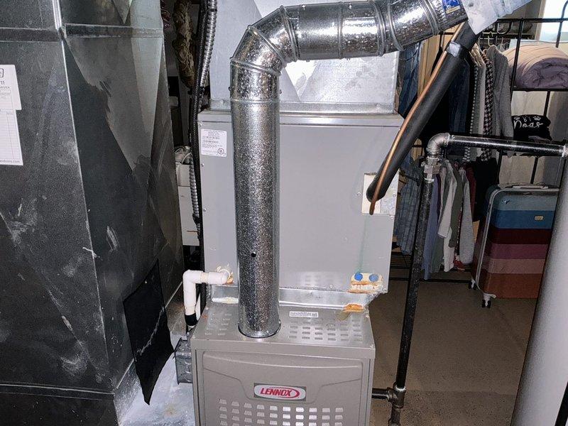 Conducted on-site assessment of existing HVAC system in residential basement to provide replacement estimate. Inspected Lennox furnace unit and associated ductwork, noting moisture present on metallic supply duct. Evaluated current equipment configuration including vertical and horizontal duct runs. Quoted leak search service and provided comprehensive replacement estimate for air conditioning system.