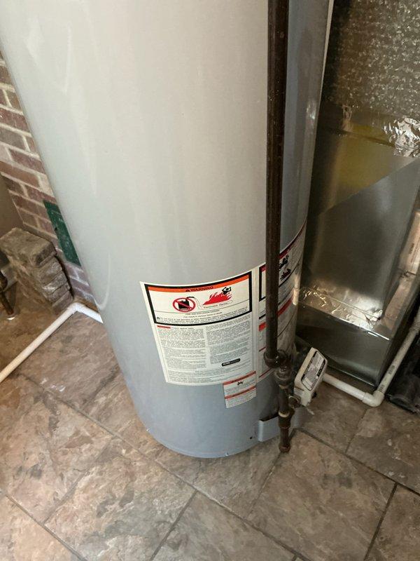Conducted on-site assessment of 10.5-year-old 40-gallon residential water heater showing visible signs of deterioration, including significant rust staining around top pipe connections and fittings. Provided estimate for complete water heater replacement unit with professional installation recommendations.