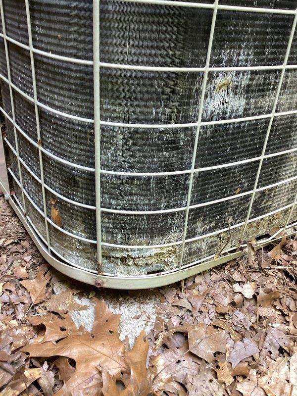 Responded to service call for reduced cooling capacity affecting entire home. Upon inspection, found outdoor condenser unit with heavily clogged coil fins due to excessive dirt, debris, and organic matter accumulation. Condenser coils showed significant blockage restricting airflow, with visible mold and mildew buildup on surfaces. Performed thorough coil cleaning to restore proper airflow through condenser fins. Removed accumulated leaves and debris from unit base and surrounding area. After cleaning, system airflow significantly improved. Checked refrigerant pressures and found levels within acceptable range—no recharge required. Verified indoor Lennox furnace and Aprilaire humidifier components operating properly. System tested and confirmed cooling performance restored to normal operation.