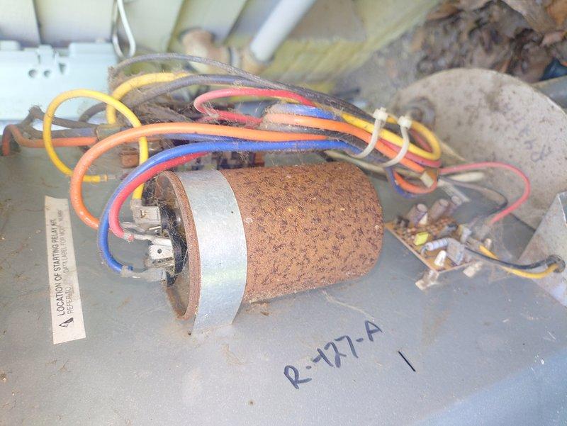 Responded to no cooling complaint on 5-year-old air conditioning system. Upon inspection, discovered heavily corroded capacitor with extensive rust and surface degradation indicating moisture exposure and component failure. Replaced failed capacitor and verified system operation. Advised customer that current unit capacity appears adequate for cooling needs, and that adding another unit is not necessary at this time.