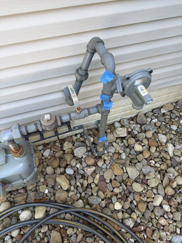 Responded to plumbing service call for gas line reconnection at exterior of residence. Upon arrival, assessed outdoor gas line assembly and verified proper connection points. Reconnected gas line to existing infrastructure mounted against building exterior, ensuring all fittings were secure and properly sealed. Performed pressure testing to confirm leak-free operation and system integrity before completing the service.