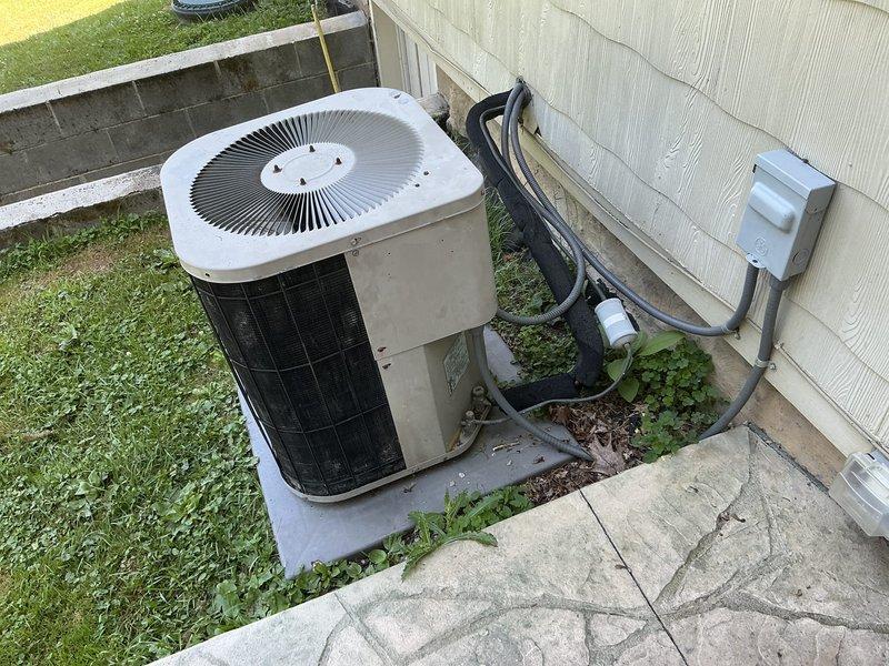 Completed site assessment for aging residential air conditioning system experiencing refrigerant leak and no cooling condition. Evaluated existing outdoor condenser unit with deteriorated components and confirmed system replacement recommendation. Documented equipment location, electrical disconnect configuration, and refrigerant line routing for replacement installation planning.