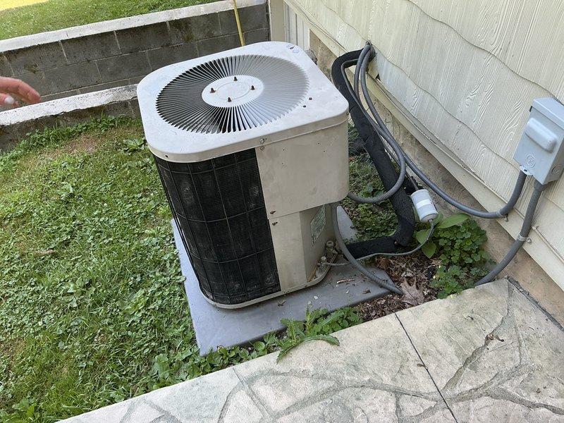 Completed site assessment for aging residential air conditioning system experiencing refrigerant leak and no cooling condition. Evaluated existing outdoor condenser unit with deteriorated components and confirmed system replacement recommendation. Documented equipment location, electrical disconnect configuration, and refrigerant line routing for replacement installation planning.