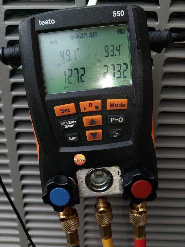 Completed installation of new air conditioning system with evaporator coil. System was properly charged with refrigerant, pressures and temperatures verified using digital manifold gauges, and all refrigerant line connections secured at outdoor condensing unit with appropriate insulation applied to prevent condensation.