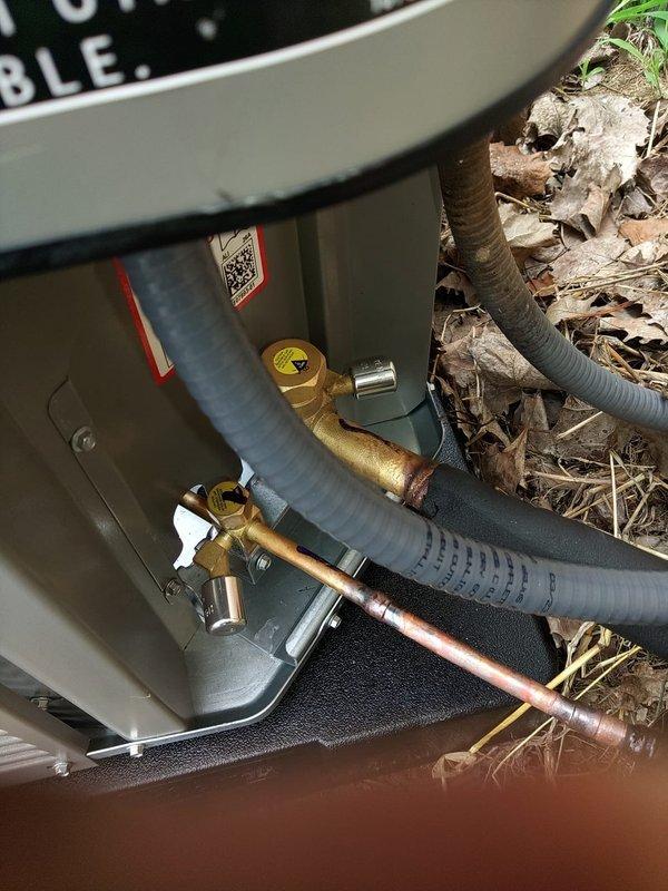 Completed installation of new air conditioning system with evaporator coil. System was properly charged with refrigerant, pressures and temperatures verified using digital manifold gauges, and all refrigerant line connections secured at outdoor condensing unit with appropriate insulation applied to prevent condensation.