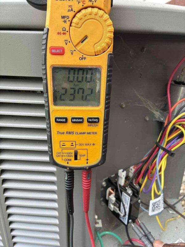 Completed preventive maintenance cooling visit on HVAC system. Performed electrical diagnostics using clamp meter, recording 20.0A current draw and 237.2V supply voltage at contactor. Inspected and replaced dual fuse assembly containing GE and Littelfuse FLNR 25A Class RK5 fuses to ensure proper overcurrent protection for system operation.