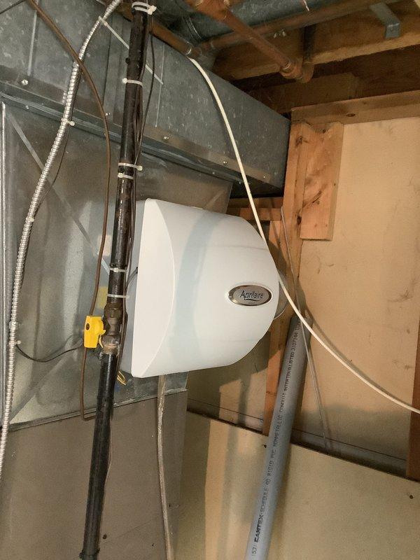 Completed estimate for furnace and air conditioning system replacement. Existing installation includes Luxaire furnace with proper PVC venting, Aprilaire humidifier mounted to main supply ductwork, and associated mechanical components in basement utility area. All equipment evaluated for replacement sizing and configuration requirements.