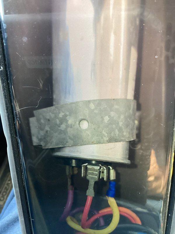 # HVAC Service Report: Window A/C Unit - No Cooling

Responded to service call for window air conditioning unit over 10 years old blowing warm air instead of cooling. Upon inspection, accessed internal electrical components and wiring connections. Performed insulation resistance testing using megohmmeter to diagnose compressor and electrical system integrity. Testing revealed compromised compressor windings reading in the caution/bad range, indicating internal electrical failure typical of aged units. Explained findings and recommended unit replacement due to age and failed compressor component.
