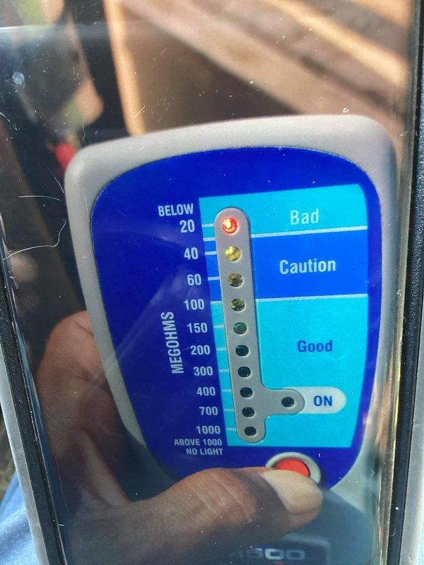 # HVAC Service Report: Window A/C Unit - No Cooling

Responded to service call for window air conditioning unit over 10 years old blowing warm air instead of cooling. Upon inspection, accessed internal electrical components and wiring connections. Performed insulation resistance testing using megohmmeter to diagnose compressor and electrical system integrity. Testing revealed compromised compressor windings reading in the caution/bad range, indicating internal electrical failure typical of aged units. Explained findings and recommended unit replacement due to age and failed compressor component.