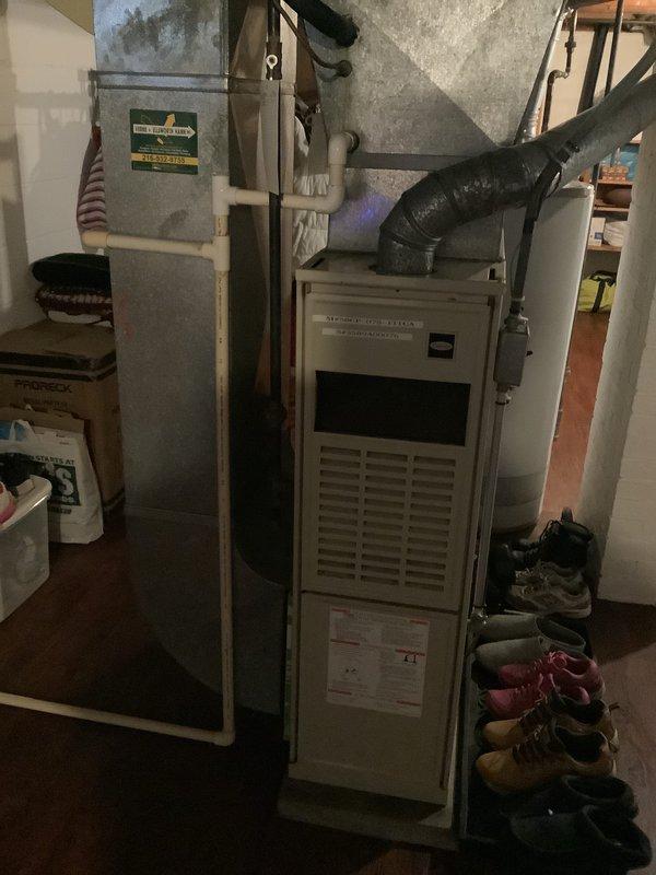 Conducted on-site evaluation of existing HVAC system in residential basement for replacement estimate. Assessed aging furnace unit and associated ductwork, documented current equipment configuration including flexible duct connections and PVC drainage lines, and photographed existing installation to provide comprehensive replacement options for outdated heating and cooling system.