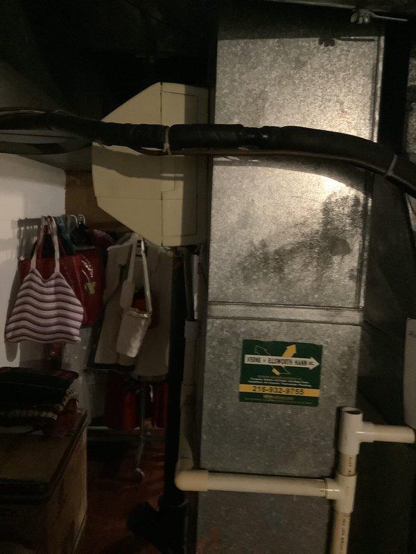 Conducted on-site evaluation of existing HVAC system in residential basement for replacement estimate. Assessed aging furnace unit and associated ductwork, documented current equipment configuration including flexible duct connections and PVC drainage lines, and photographed existing installation to provide comprehensive replacement options for outdated heating and cooling system.